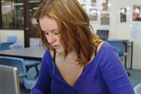 Student working on laptop in library